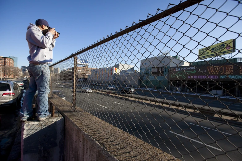 a man that is looking over a fence