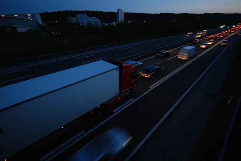 many long trucks on the road during the night