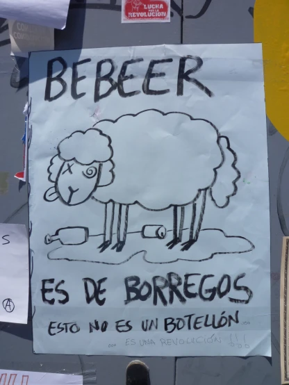 a sign posted on a wall saying beber, es de borregos