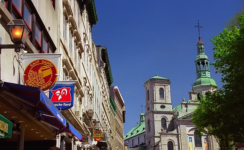 people walking down a street with a church in the background