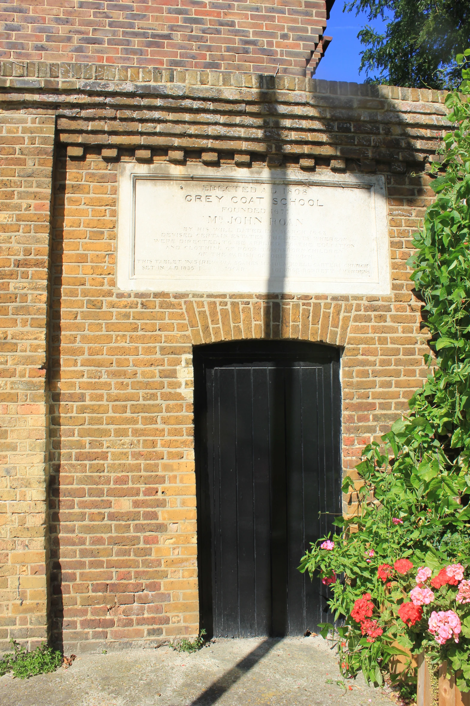 a wall with a black doorway in the middle of it