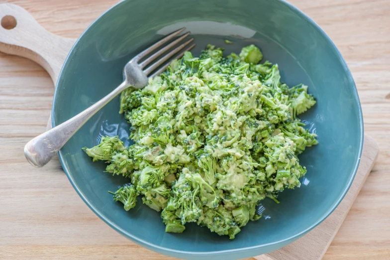 the bowl has vegetables in it on the table