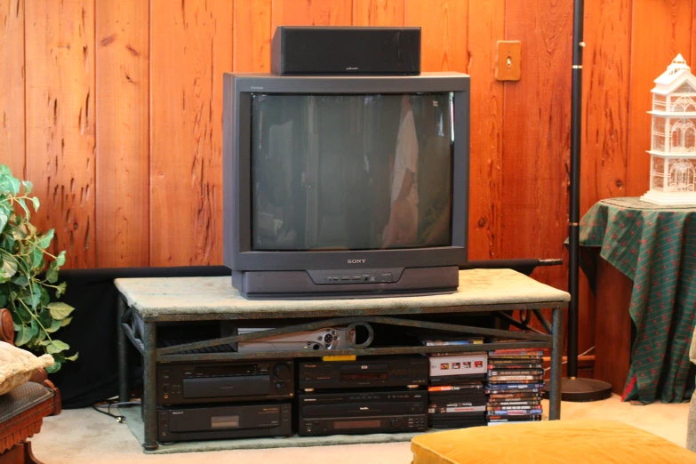 a television sits on top of a small tv stand