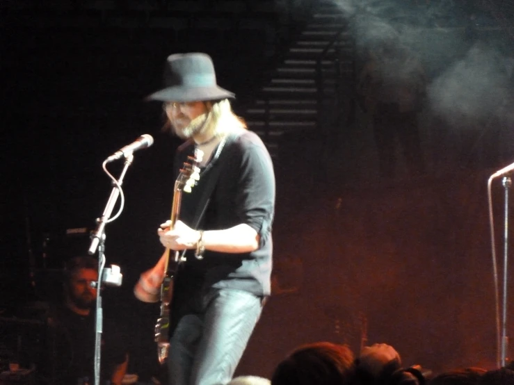 a man on stage playing a musical instrument