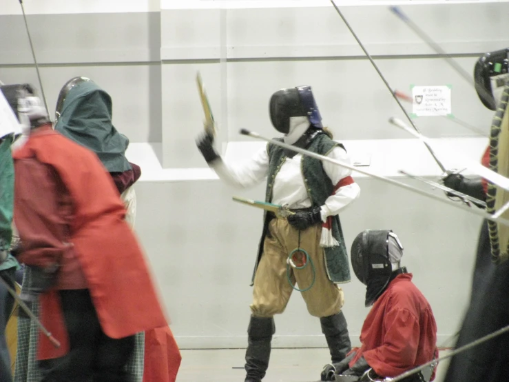 men dressed in costumes with swords on the set of star wars