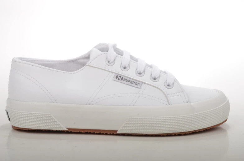 white tennis shoe with gum - colored soles