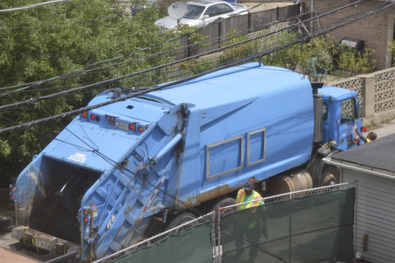 a large blue truck with it's hood flipped upside down