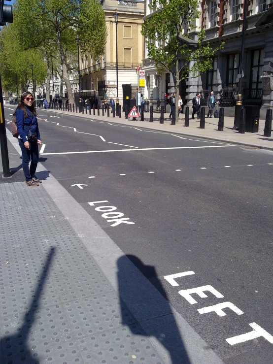 a city street with people walking on the side of it