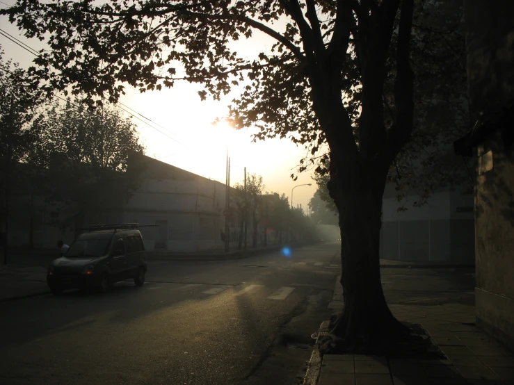 a lone car on a street during the sun down