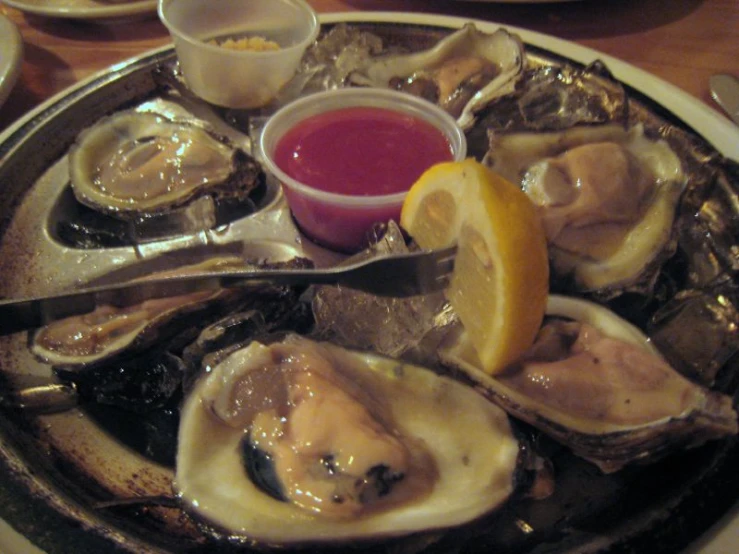 a plate filled with oysters on top of a table