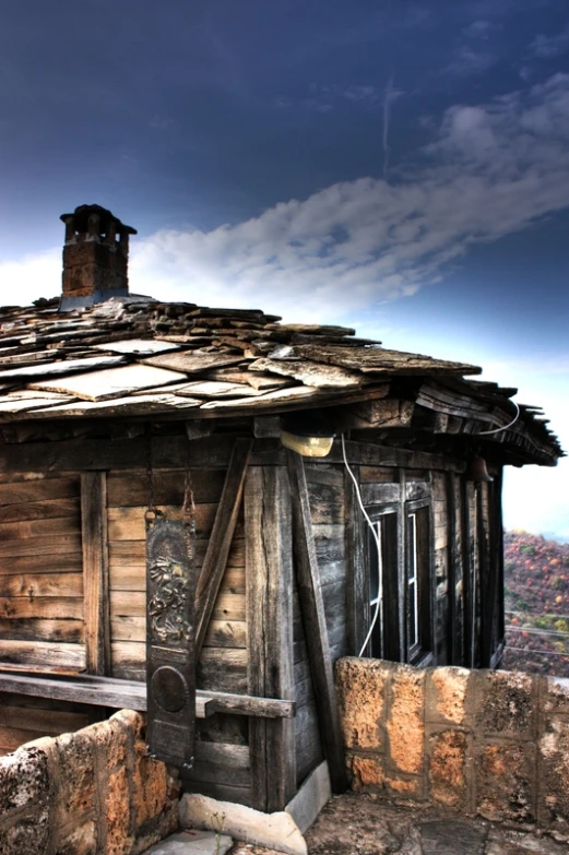 an old weathered cabin sits at the edge of a cliff