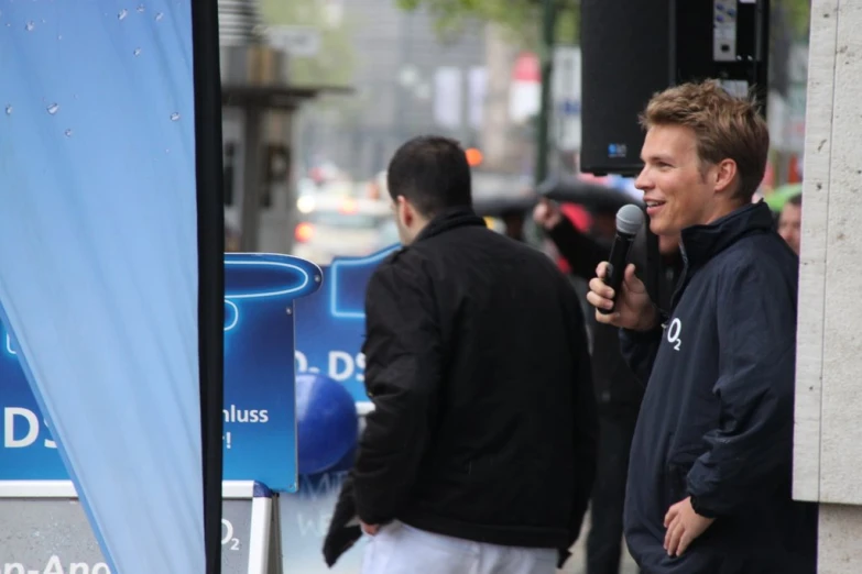 a man is standing in front of the microphone