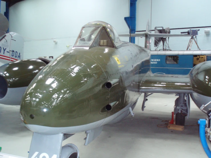 a military airplane parked in an air force hanger