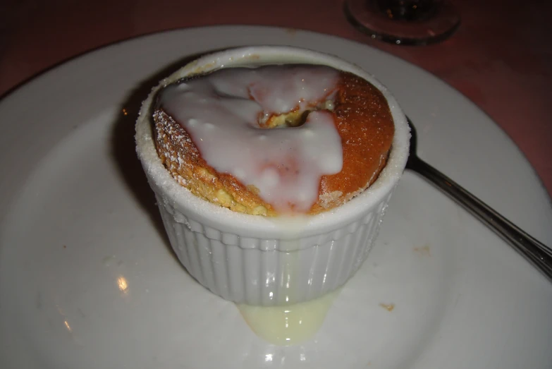 a pastry is in a sauce cup on a white plate