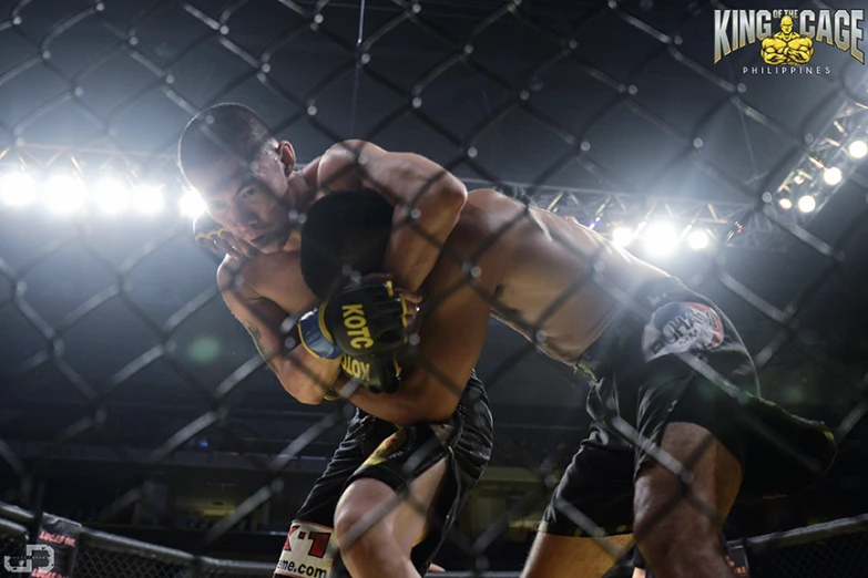 two fighters in action in the middle of the cage