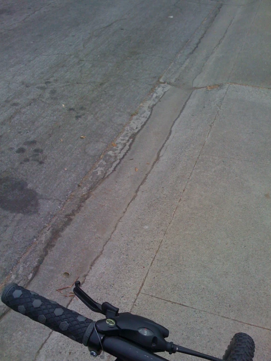 a broken black umbrella on the sidewalk