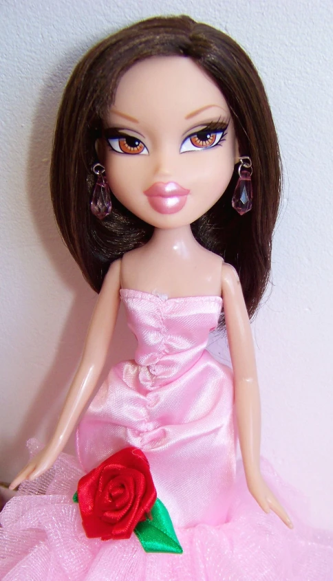 the barbie doll is wearing a pink dress