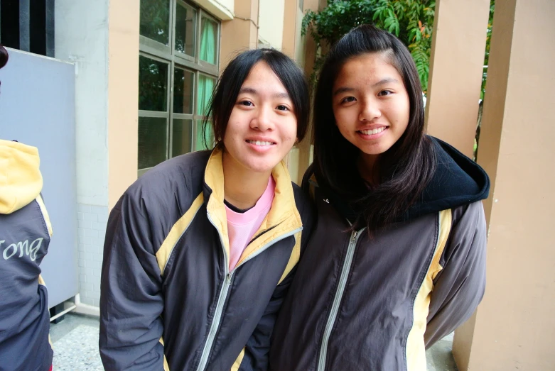 two woman who are posing for the camera