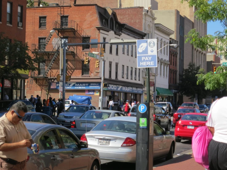 the cars are parked and people are standing around