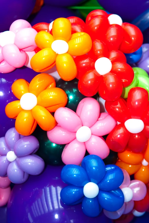 a pile of balloons that are full of flowers