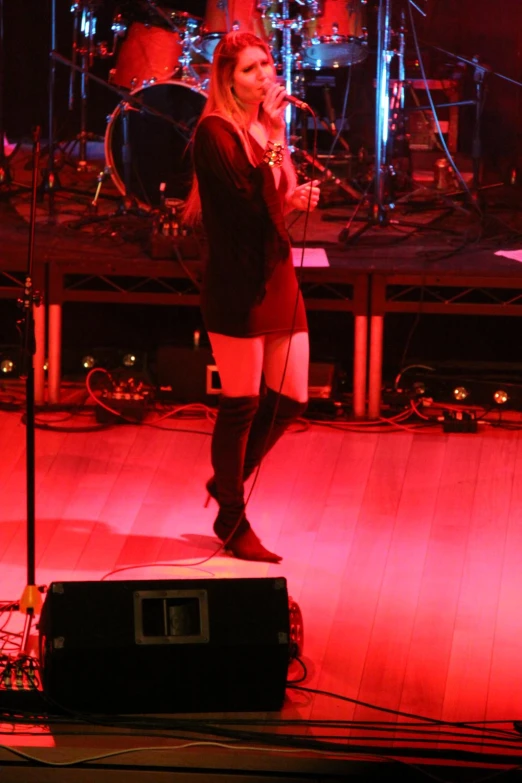 a woman in short shorts and boots on stage