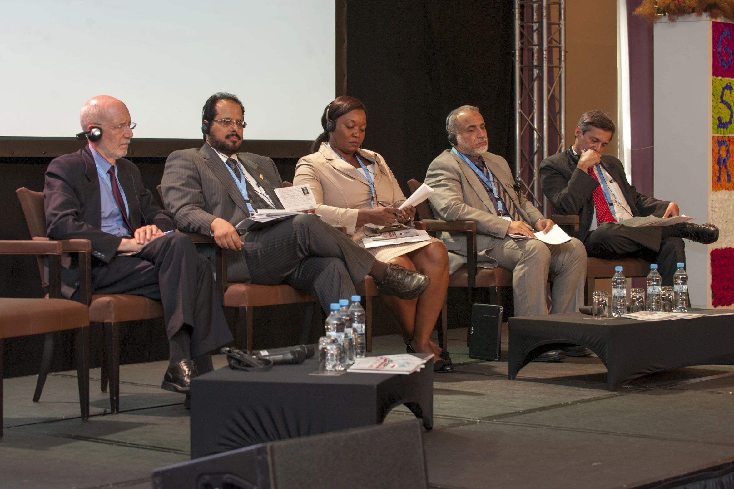 several people in conversation on stage in front of an audience