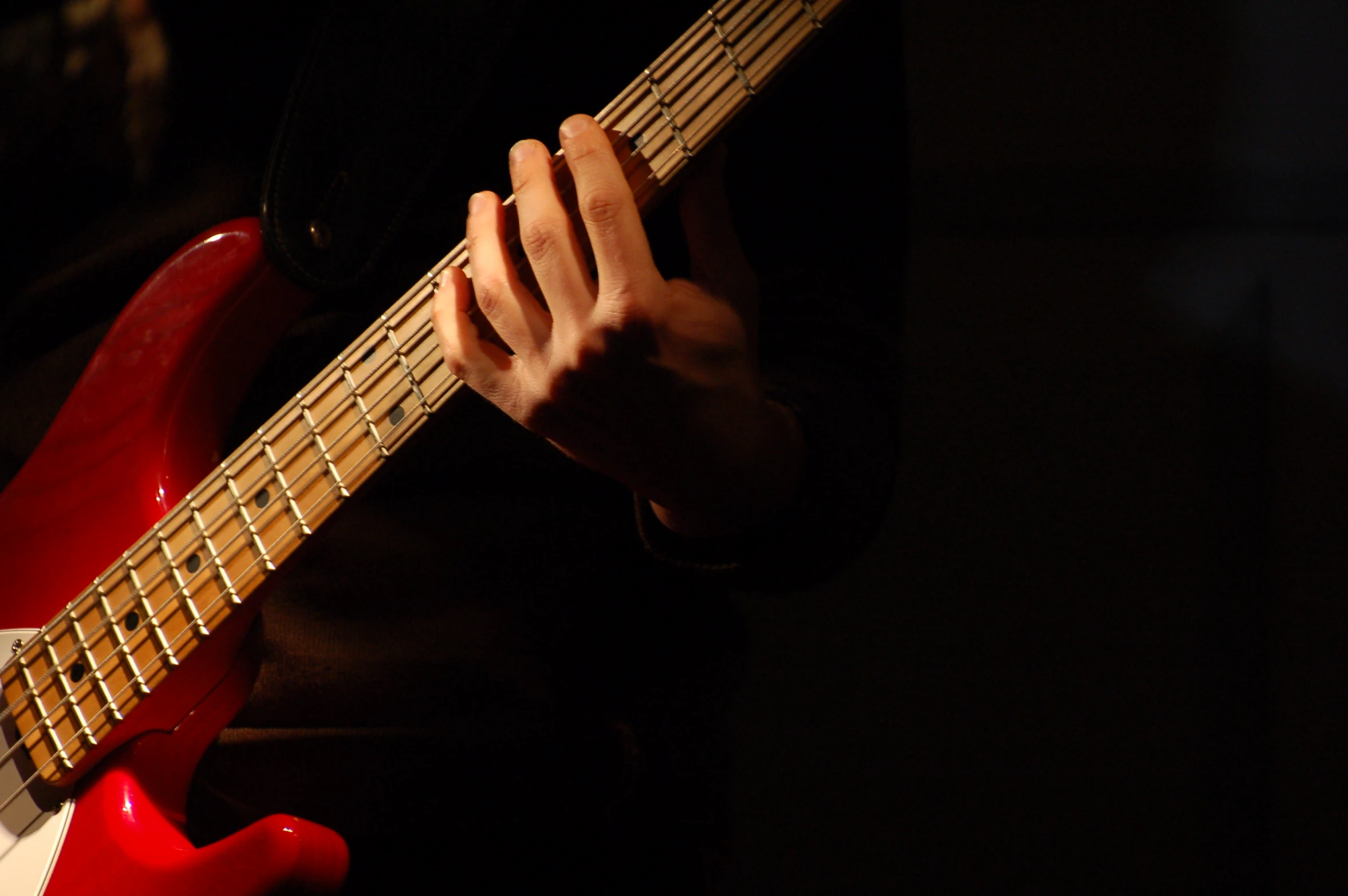 a person holding onto an electric guitar while playing it