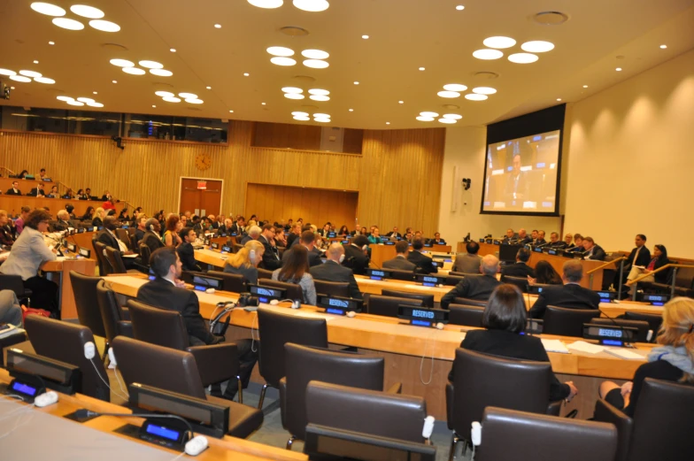 a large conference hall full of people sitting at tables