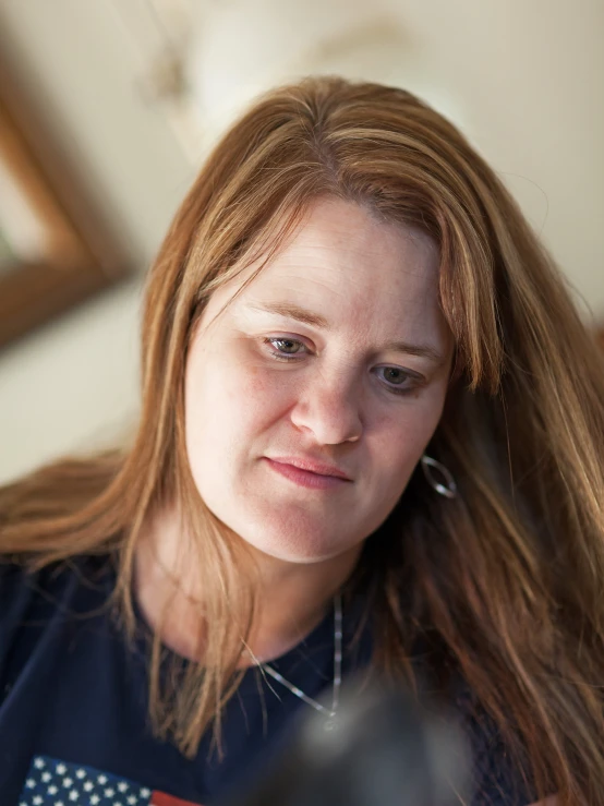 a woman in a black shirt with long red hair