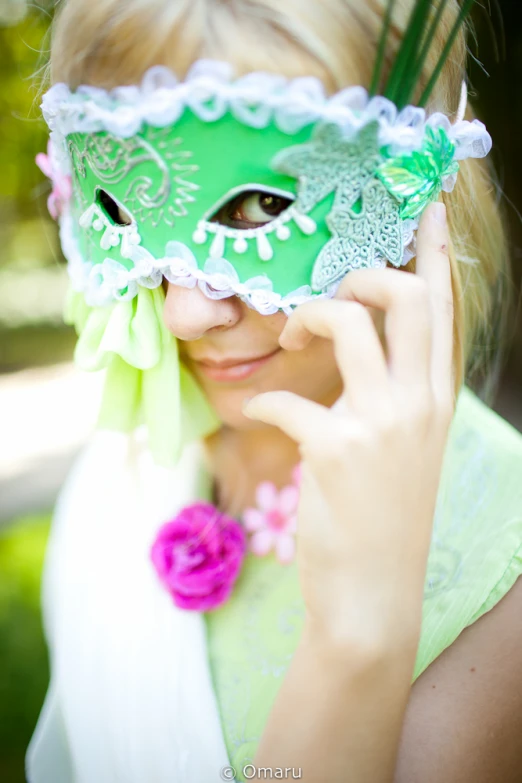 a woman wearing a green mask over her face