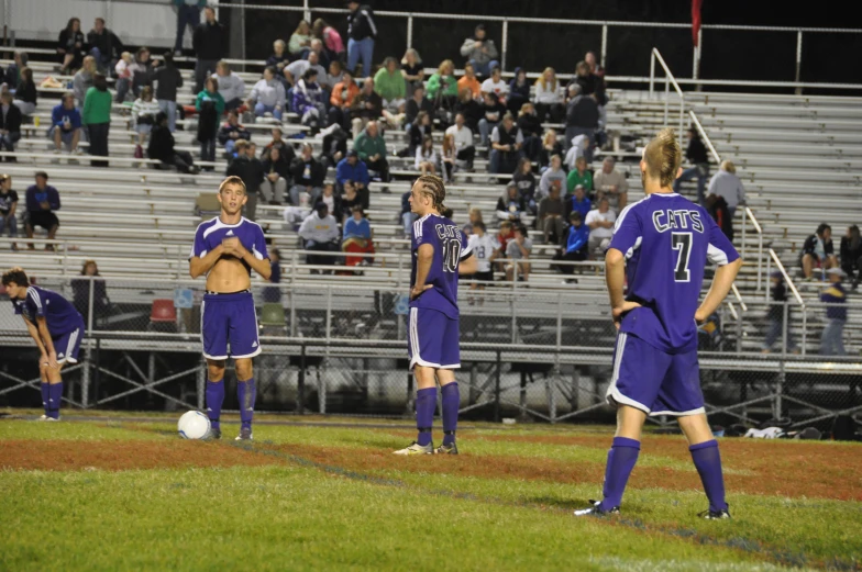 the two girls are standing on the soccer field