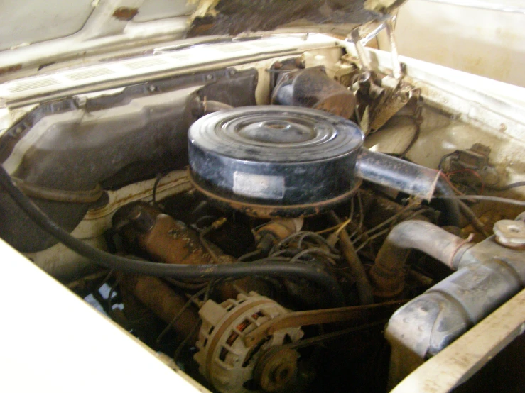 this is an old car with its engine and exhaust system exposed