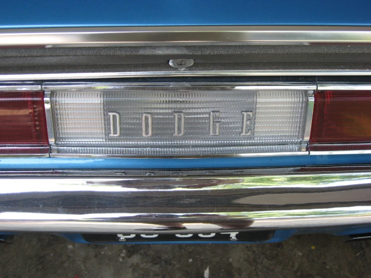 the tail light of an older car with the word dodge on it