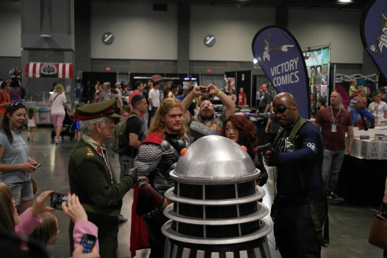 a woman standing next to a robot on display