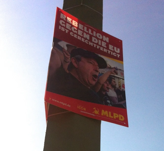 the poster shows a protest, and is attached to the city pole