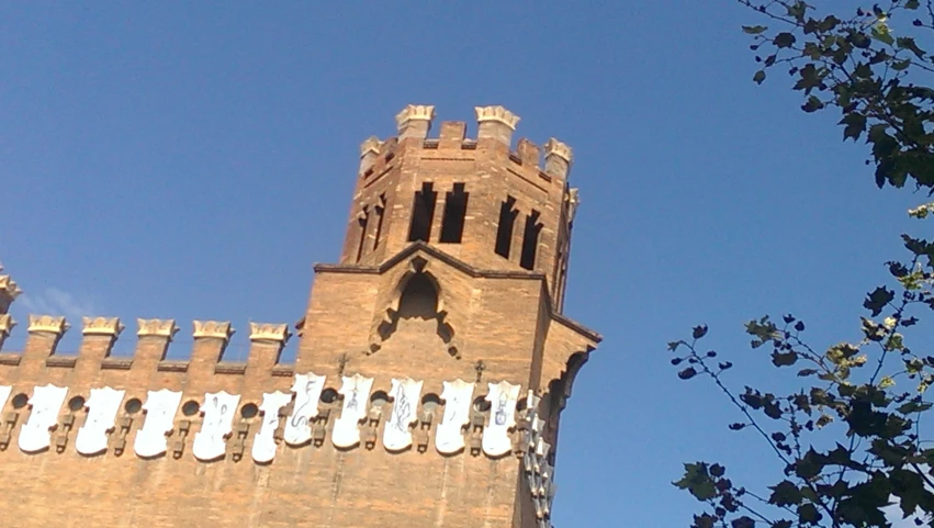 looking up at a castle like building with a clock tower