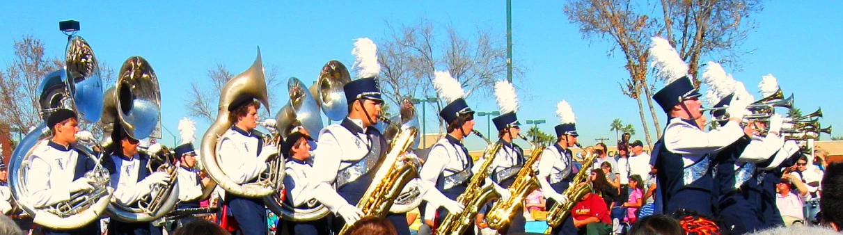 a band wearing uniform playing on large musical instruments
