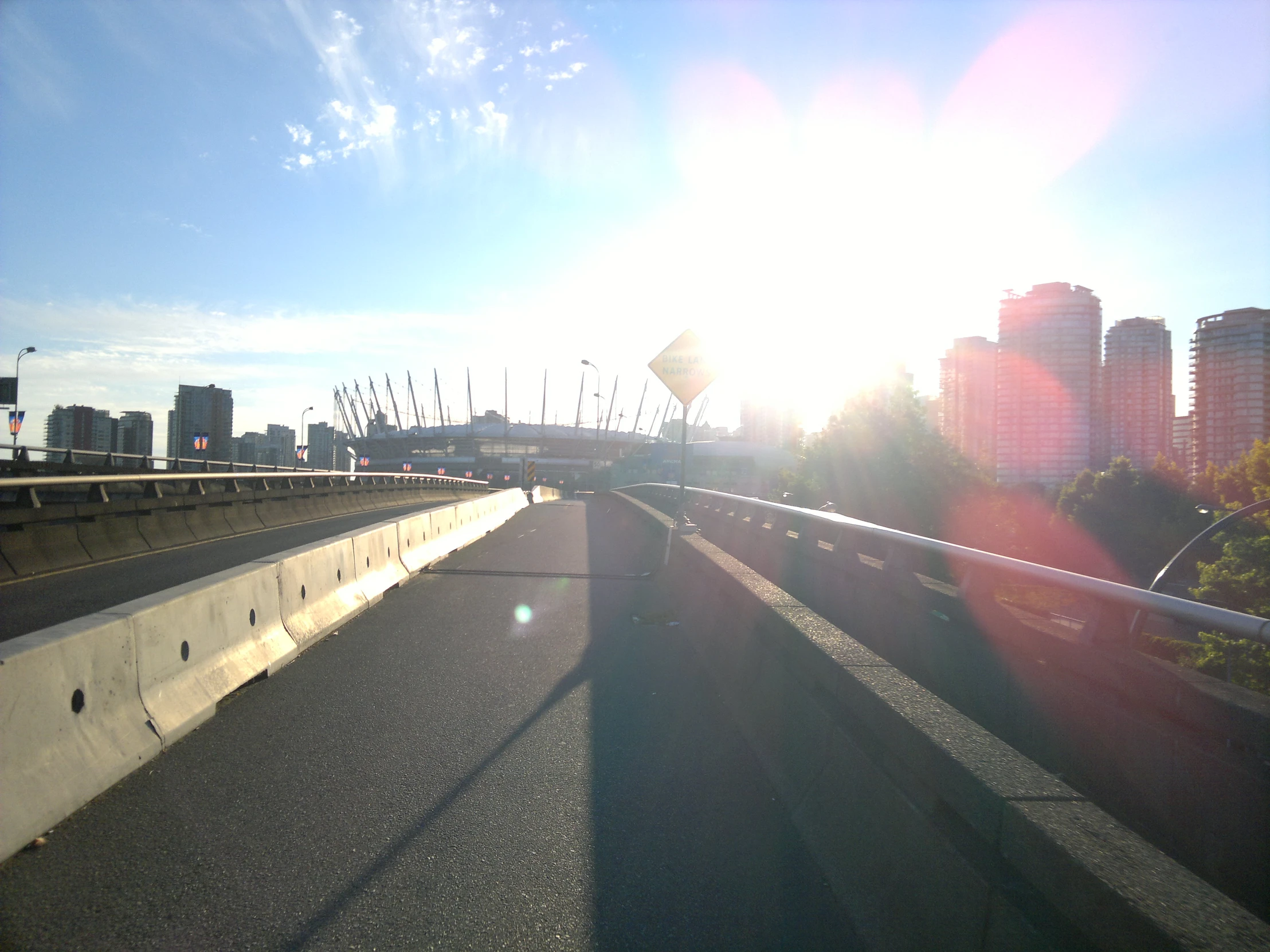 sunlight shining from a building overpass as seen from the side