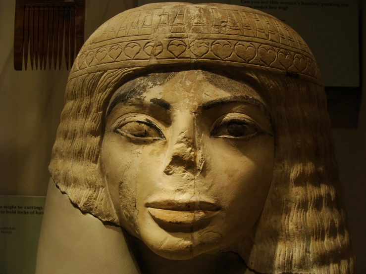 statue of egyptian woman in headpiece from the reign of egypt