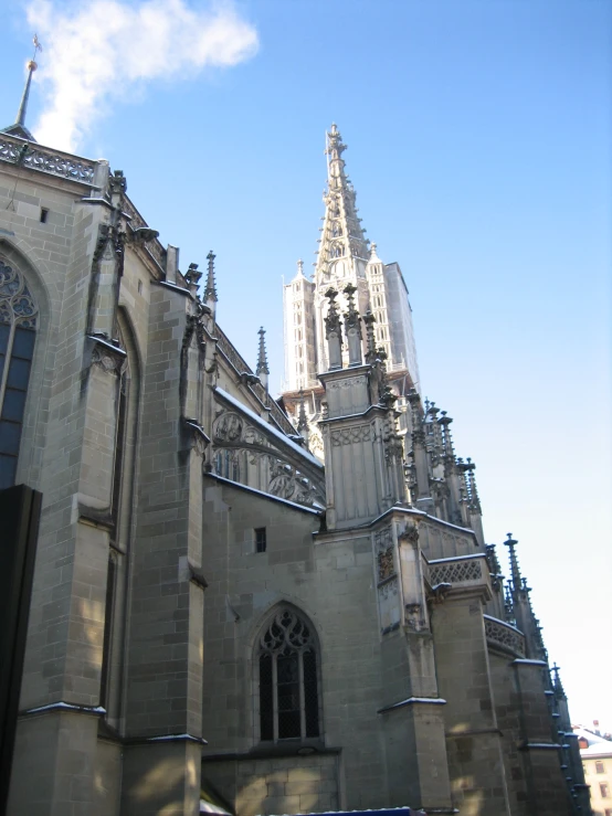 an architectural building with tall towers under a blue sky