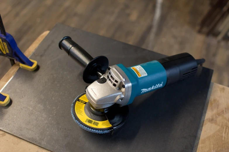 a sander on a wood floor with a power tool