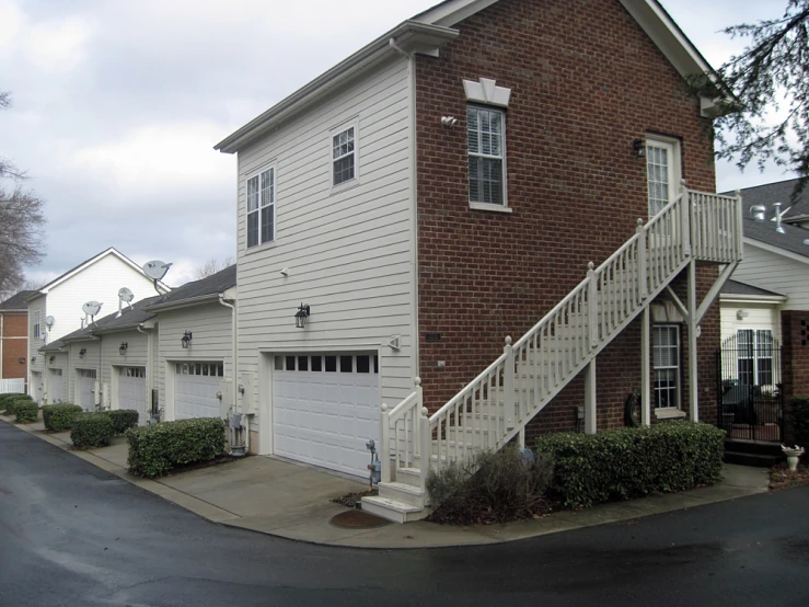 the front view of a three story house and garage