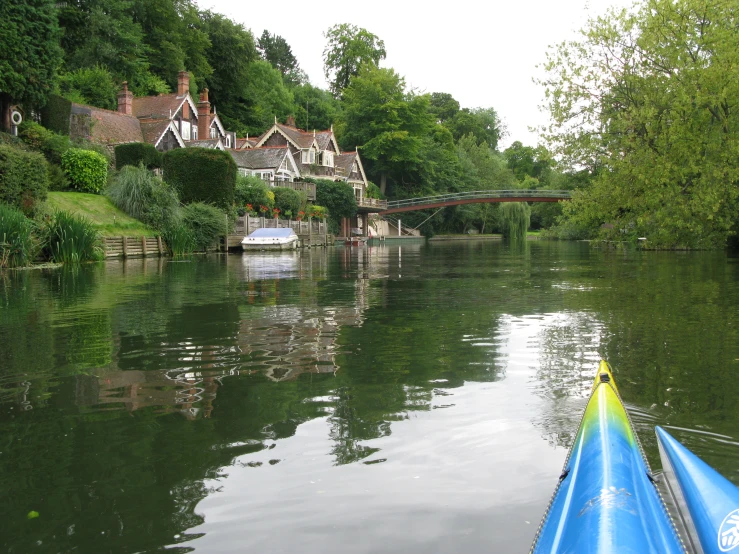 a boat is going down the river next to houses