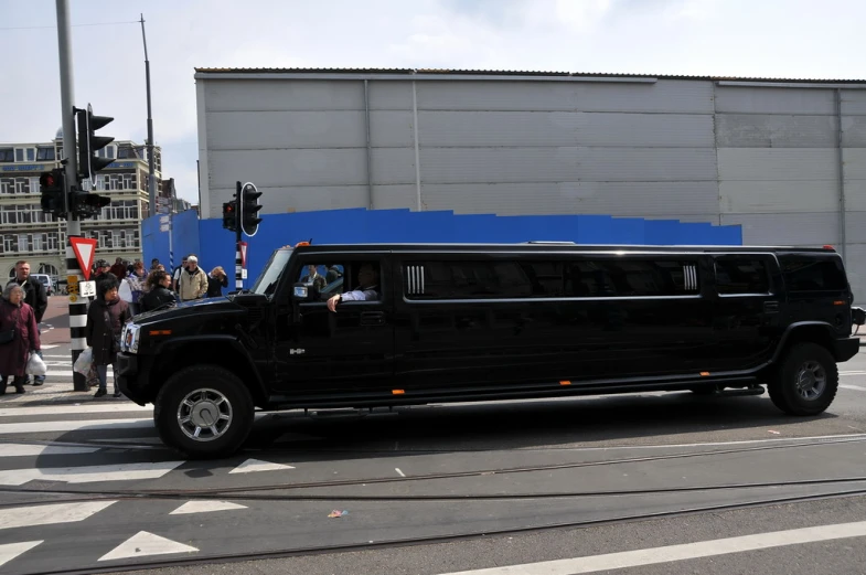 black hummer with chrome wheels on city street