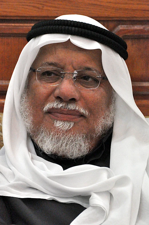 an elderly man in black and white has a big smile