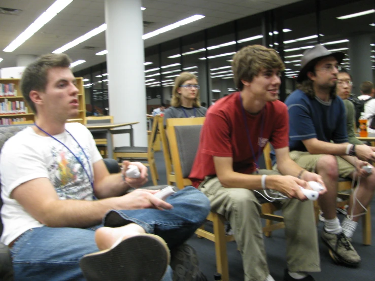 several students with video game controllers in the liry