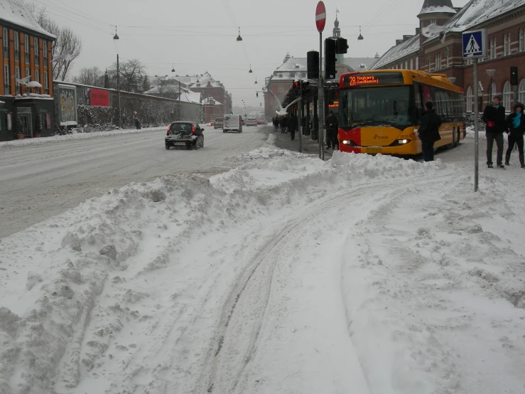 a bus is driving down a snowy street