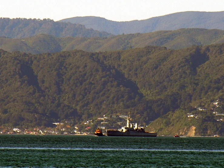 boat on the ocean with mountains in background