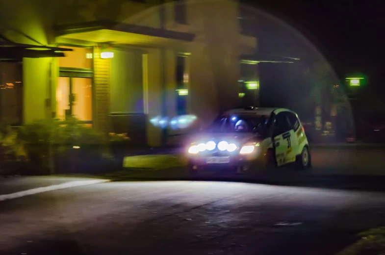 police car in street lights with house behind