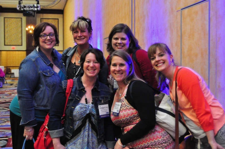 group po in front of colorful wall at conference